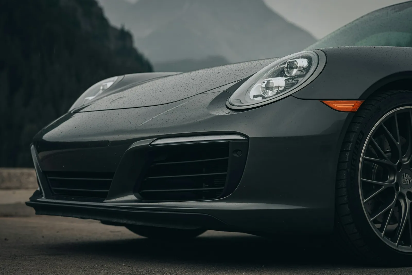 Licensed editorial front detail of a grey car in rain, as used on The Car Sourcer website; not stock offered for sale.